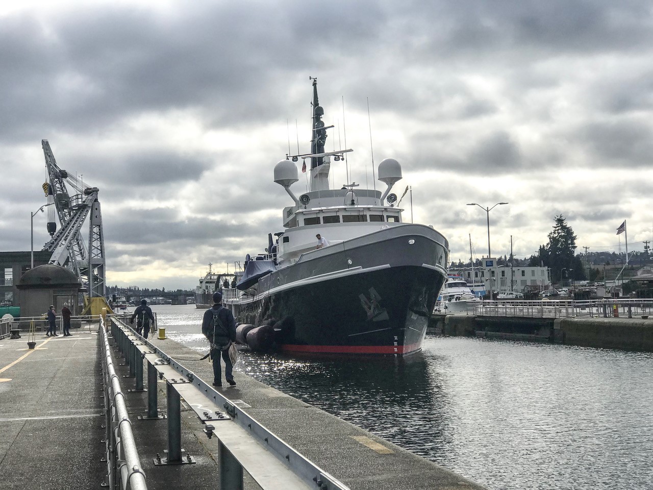 Motor yacht Itasca transiting a lock under cloudy skies.